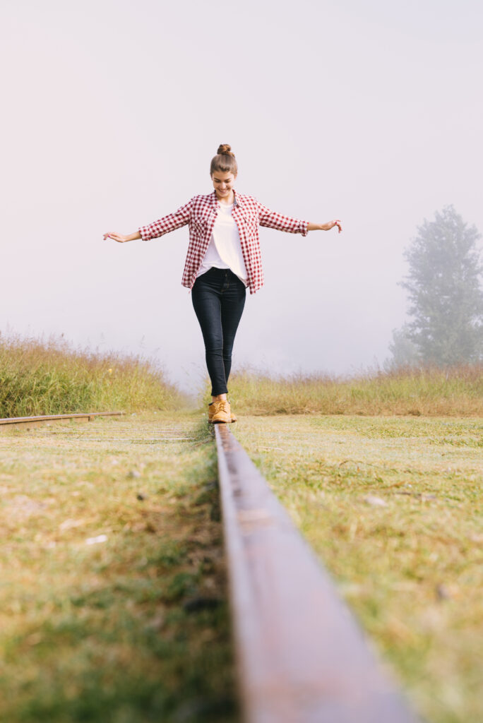 low-angle-young-girl-balancing-railway